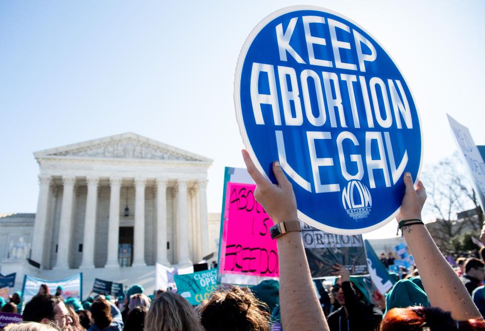 Activists supporting legal access to abortion protest March 4 outside the Supreme Court in Washington as justices heard oral arguments regarding a Louisiana law about abortion access in the first major abortion case in years.