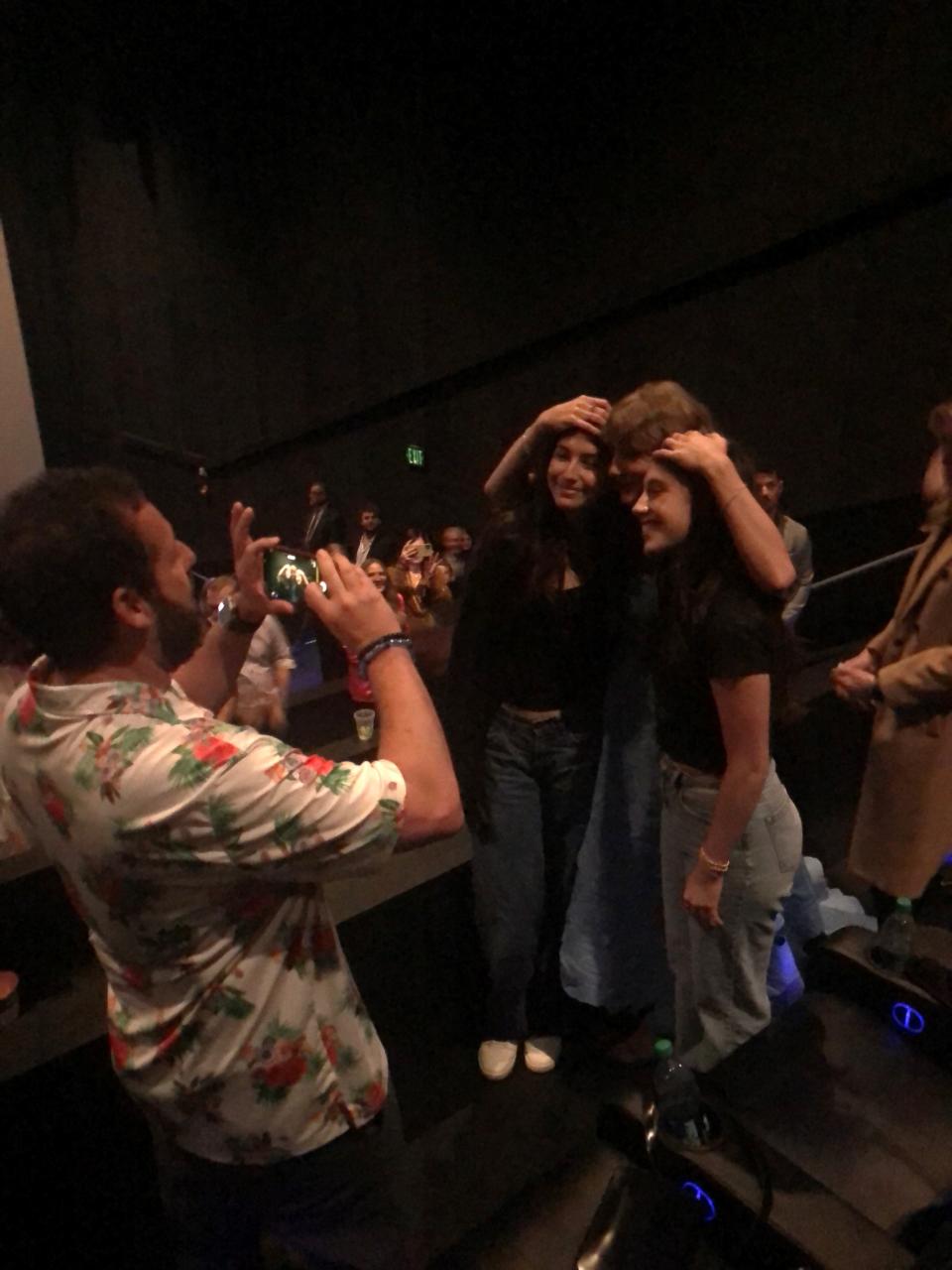 Adam Sandler takes a photo of Taylor Swift and his daughters after the world premiere of the "Era's Tour" movie.