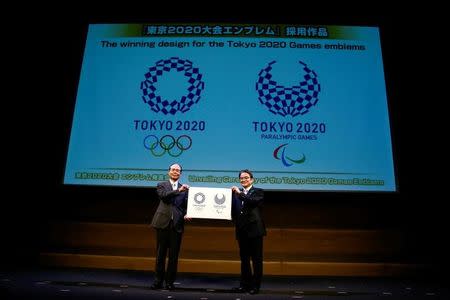 Tokyo 2020 Emblems Selection Committee Chairperson Ryohei Miyata (R) and committee member Sadaharu Oh present the winning design of the Tokyo 2020 Olympic Games and Paralympic Games during its unveiling ceremony in Tokyo, Japan April 25, 2016. REUTERS/Thomas Peter