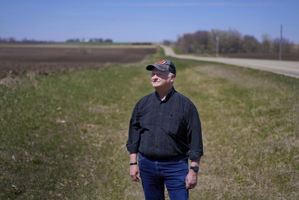 The Rev. Alan Blankenfeld, the rural ministry liaison for the Evangelical Lutheran Church in America's South Dakota synod, stands in a ditch beside Todd Sanderson's corn field on Wednesday, May 3, 2023, in Flandreau, S.D. A few years ago, Blankenfeld started a suicide prevention program with Sanderson's help that includes Spanish information, since many dairy workers there are immigrants. (AP Photo/Jessie Wardarski)