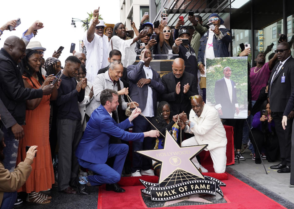 Fans, friends and family of the late rapper/actor Tupac Shakur cheer as they reveal his new star on the Hollywood Walk of Fame during a ceremony on Wednesday, June 7, 2023, in Los Angeles. (AP Photo/Chris Pizzello)