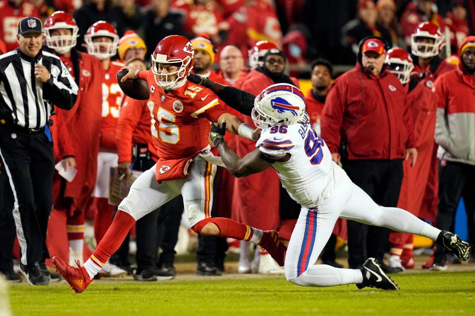 Jan 23, 2022; Kansas City, Missouri, USA; Kansas City Chiefs quarterback Patrick Mahomes (15) scrambles up the field against Buffalo Bills defensive end Boogie Basham (96) during the third quarter of the AFC Divisional playoff football game at GEHA Field at Arrowhead Stadium. Mandatory Credit: Jay Biggerstaff-USA TODAY Sports