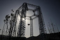 A lander is lifted during a test of hovering, obstacle avoidance and deceleration capabilities at a facility in Huailai in China's Hebei province, Thursday, Nov. 14, 2019. China has invited international observers to the test of its Mars lander as it pushes for inclusion in more global space projects. Thursday's test was conducted at a site outside Beijing simulating conditions on the Red Planet, where the pull of gravity is about one-third that of Earth. (AP Photo/Andy Wong)