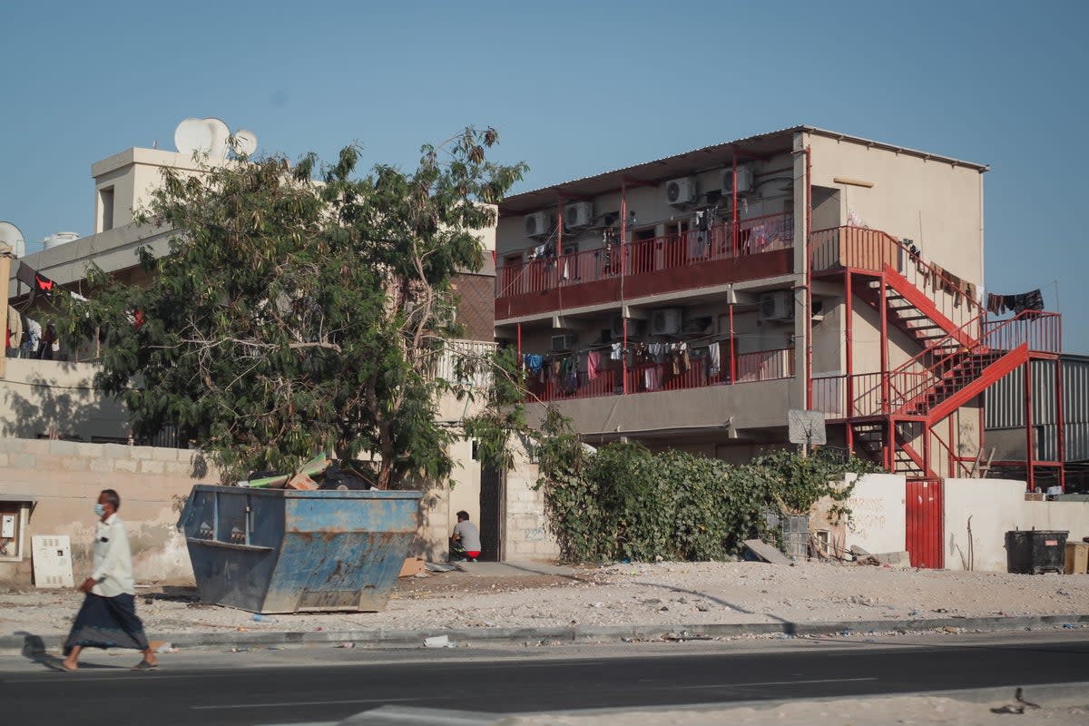 A man walks past an accommodation block in the Industrial Area (Quentin Muller)