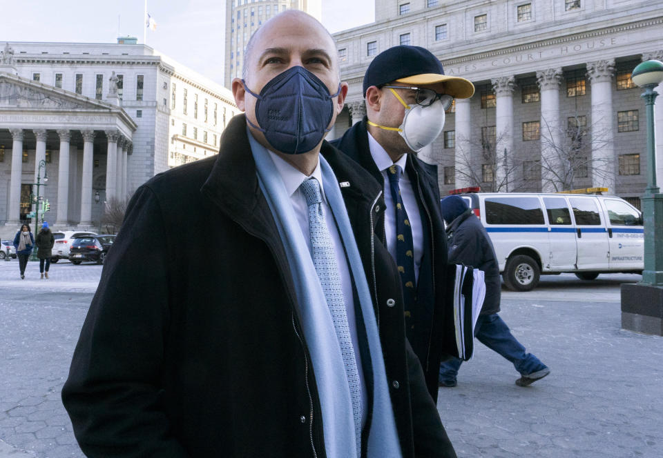 Michael Avenatti, left, leaves Federal court in Manhattan, Friday, Jan. 21, 2022. Avenatti, the once high-profile California attorney who regularly taunted then-President Donald Trump, was introduced to prospective jurors who will decide whether he cheated porn star Stormy Daniels out of hundreds of thousands of dollars. (AP Photo/Mary Altaffer)