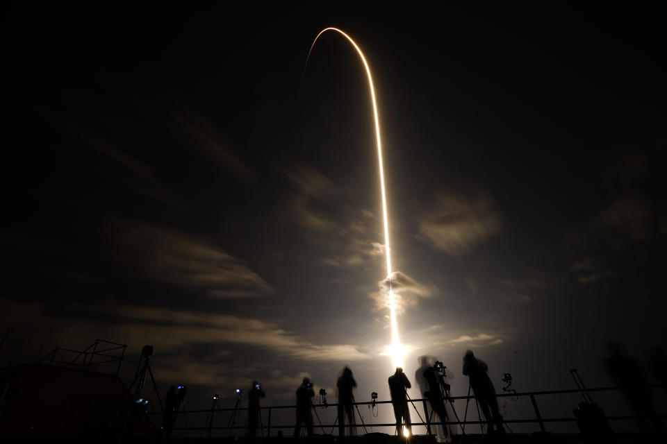 FILE - In this April 23, 2021 file photo, a SpaceX Falcon 9 lifts off in this time exposure from Launch Complex 39A at the Kennedy Space Center in Cape Canaveral, Fla., carrying four astronauts to the International Space Station. Russia's space chief said Tuesday, July 26, 2022, that they will opt out of the International Space Station after 2024 and focus on building its own orbiting outpost. (AP Photo/Chris O'Meara, file)