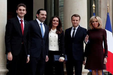 French President Emmanuel Macron and his wife Brigitte Macron, Saad al-Hariri, who announced his resignation as Lebanon's prime minister while on a visit to Saudi Arabia, his wife Lara and their son Houssam are pictured at the Elysee Palace in Paris, France, November 18, 2017. REUTERS/Benoit Tessier