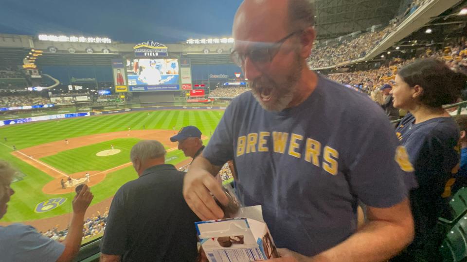 Ed Creech celebrates a Milwaukee Brewers home run on Tuesday by giving fans Ding Dongs. Creech has been giving surrounding fans near his seats Ding Dongs to celebrate home runs since 2018.