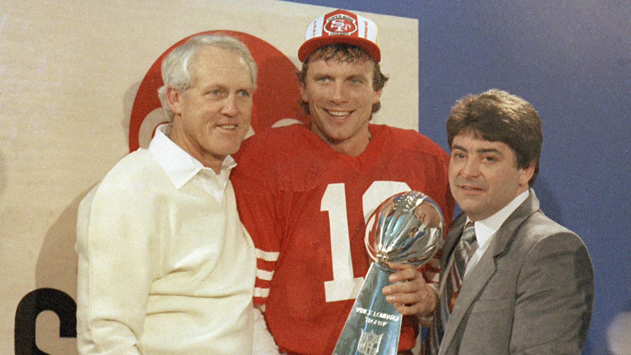 Mandatory Credit: Photo by AP/Shutterstock (6578123a)Walsh DeBartolo Montana San Francisco 49ers' quarterback Joe Montana, center, is shown holding the Lombardi Super Bowl trophy with coach Bill Walsh, left, and 49ers' owner Edward DeBartolo, Jr.