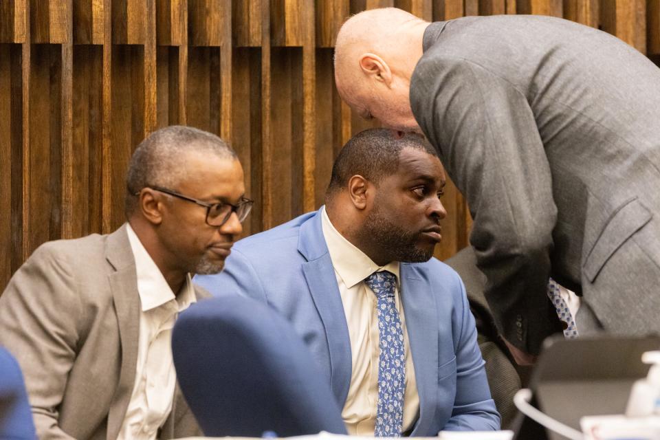 Former University of Oregon football coach Willie Taggart, left, and former strength coach Irele Oderinde consult with attorney Stephen English during a trial against the two men, the university and the NCAA by former football player Doug Brenner on Wednesday, April 13, 2022. The former UO football player is seeking $125.5 million in the lawsuit.