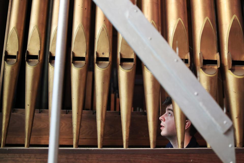 Zack Emerson of William H. Longmore & Associates from Lakeland looks at organ pipes at the Basilica of The Immaculate Conception n Jacksonville. The old organ is undergoing a much-needed renovation at a cost of $200,000.