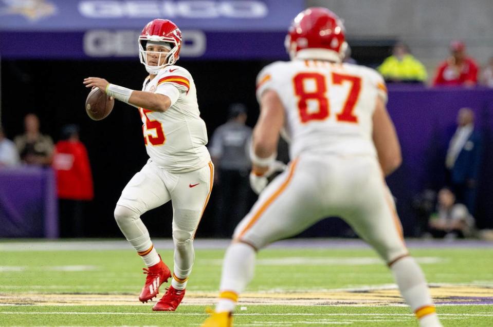 Kansas City Chiefs quarterback Patrick Mahomes (15) winds up to pass the ball to tight end Travis Kelce (87) against the Minnesota Vikings during an NFL football game on Sunday, Oct. 8, 2023, at U.S. Bank Stadium in Minneapolis, Minn. Nick Wagner/nwagner@kcstar.com