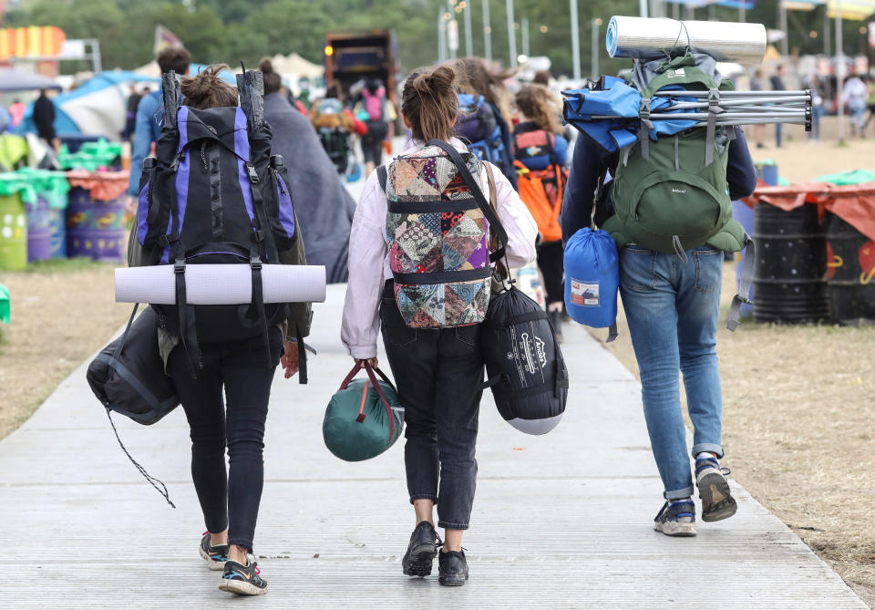 Festival goers carry tents and bags on their journey home at the 2019 Glastonbury Festival held at Worthy Farm, in Pilton, Somerset on July 1, 2019 near Glastonbury, England. The festival, founded in 1970, has grown into one of the largest outdoor green field festivals in the world. (Photo by Matt Cardy/Getty Images)