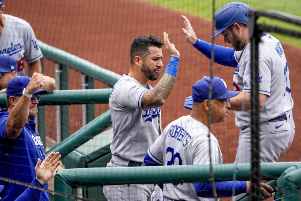 Los Angeles Dodgers' Max Muncy, right, celebrates with teammates after scoring on a single by Jason Heyward during the first inning of a baseball game against the Washington Nationals at Nationals Park, Sunday, Sept. 10, 2023, in Washington. (AP Photo/Andrew Harnik)