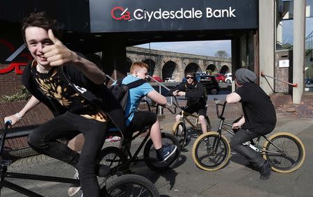 Students gather after school as they ride their bicycles in the main shopping district in Kilmarnock, Scotland April 29, 2014. REUTERS/Suzanne Plunkett