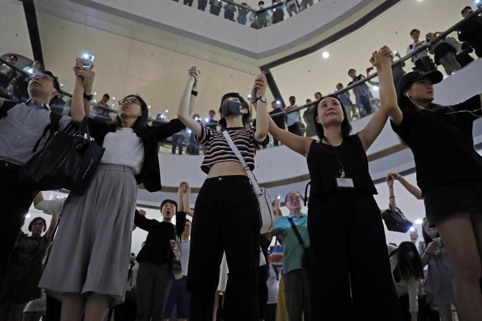 Demonstrators sing a theme song written by protestors "Glory to Hong Kong" at the International Finance Centre (ifc) shopping mall in Hong Kong, Thursday, Sept. 12, 2019. Thousands of people belted out a new protest song at Hong Kong's shopping malls in an act of resistance that highlighted the creativity of demonstrators in their months-long fight for democratic freedoms in the semi-autonomous Chinese territory. (AP Photo/Kin Cheung)