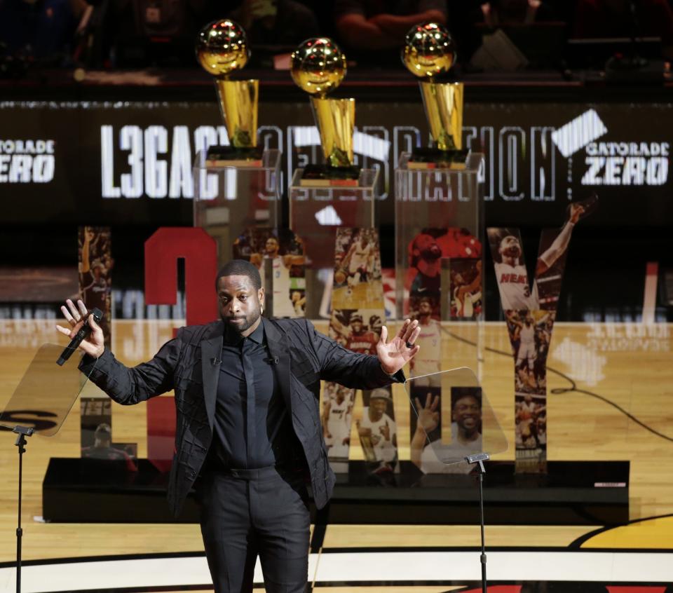 Former Miami Heat guard Dwyane Wade reacts during a ceremony for his jersey retirement at halftime as the Heat host the Cleveland Cavaliers in an NBA basketball game Saturday, Feb. 22, 2020, in Miami. (David Santiago/Miami Herald via AP)