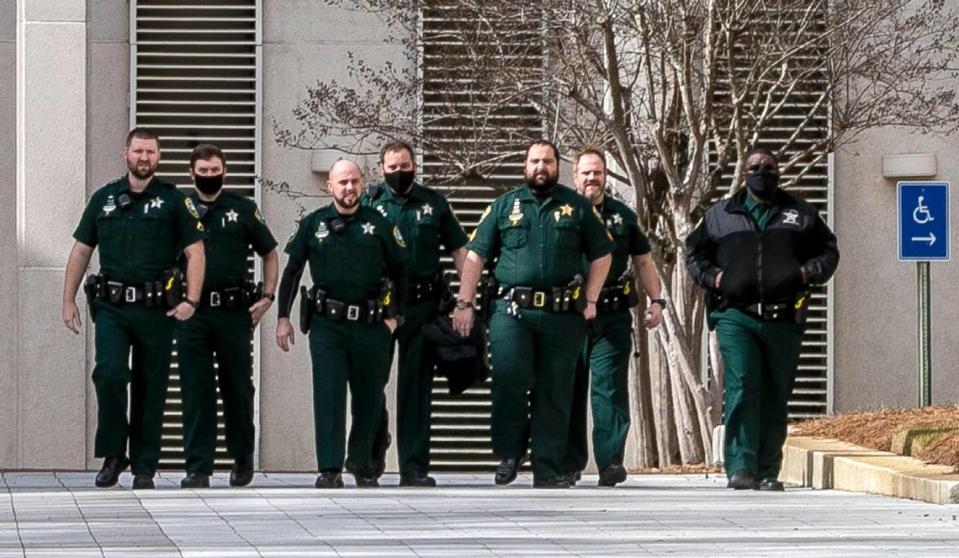 Leon County Sheriff deputies are seen at the Florida Capitol in Tallahassee early Sunday morning, Jan. 17, 2021. Law enforcement has been on high alert for possible armed marches on state capitol buildings across the country after the FBI issued a bulletin about possible pro-Trump protests before the president leaves the White House. 