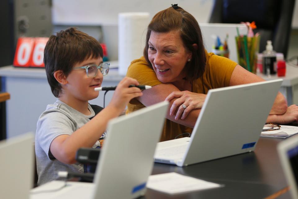 In this file photo, Westport Community Schools Director of Curriculum, Instruction and Professional Development Lisa Kaminski (right) has a moment with student Edmund Magnuski, 10, during the "Universe Reimagined" summer program held at the old Westport Junior/Senior High School building in July. The program utilized the district's new zSpace laptops as Westport Community Schools ramp up to their debut this at the high school this fall.