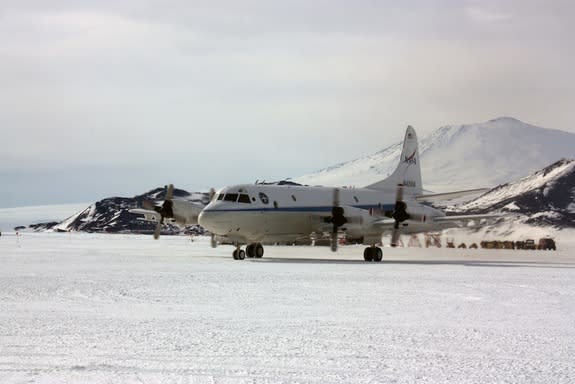 NASA's modified P-3B aircraft arrives at the National Science Foundation's McMurdo Station in Antarctica, with Mount Erebus, one of Antarctica's active volcanoes, in the background.