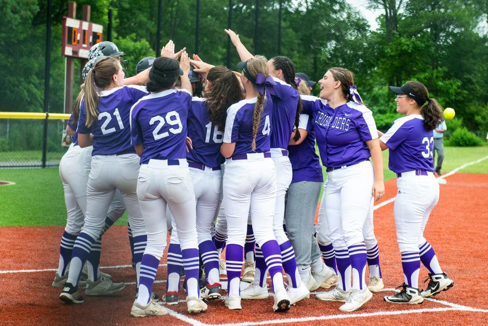 Monroe-Woodbury players welcome Emma Lawson at home plate after she scored a home-run during the semi regional Class AA softball ball game at Arlington High School in Lagrangeville, NY on Wednesday, June 1, 2022. Monroe-Woodbury defeated North Rockland 12-0.