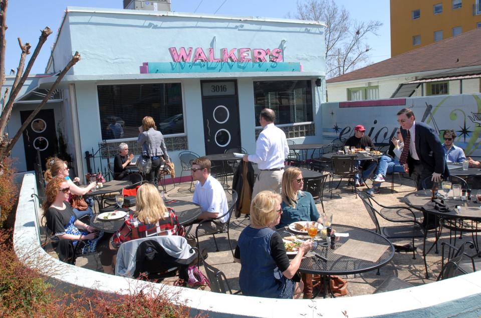 A crowd of diners enjoy lunch under clear-blue skies at Walker's Drive In in Jackson's Fondren District.