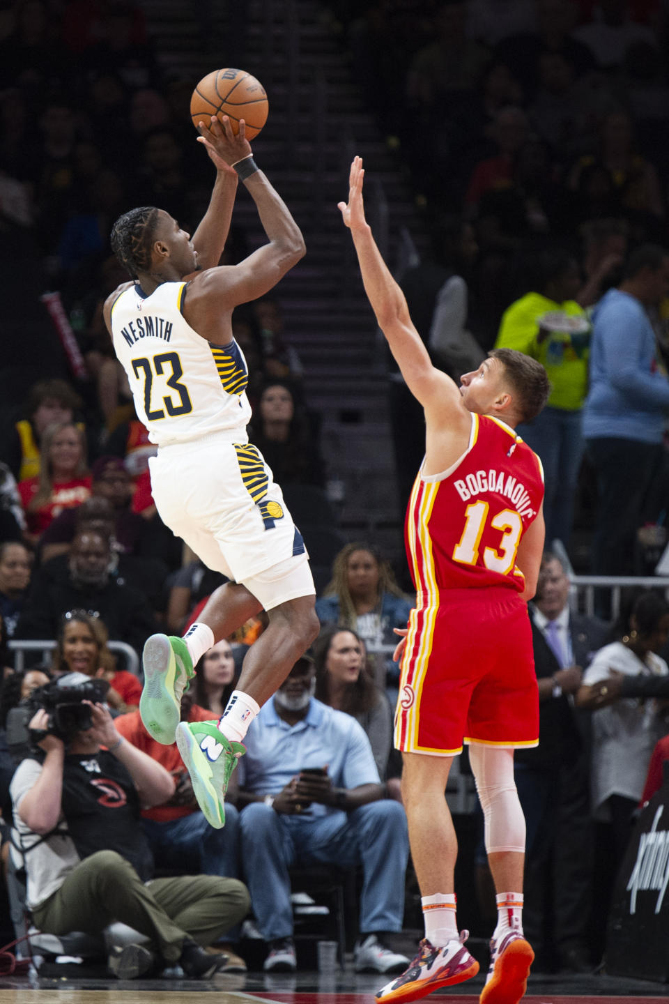 Indiana Pacers forward Aaron Nesmith shoots over Atlanta Hawks guard Bogdan Bogdanovic during the first half of an NBA basketball game, Saturday, March 25, 2023, in Atlanta. (AP Photo/Hakim Wright Sr.)