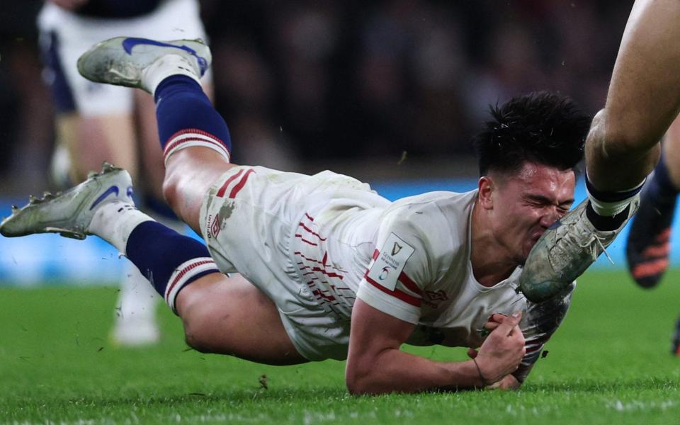 England's fly-half Marcus Smith is hit in the face/England v Scotland player ratings: Marcus Smith 'found lacking in game management department' - Adrian Dennis/AFP