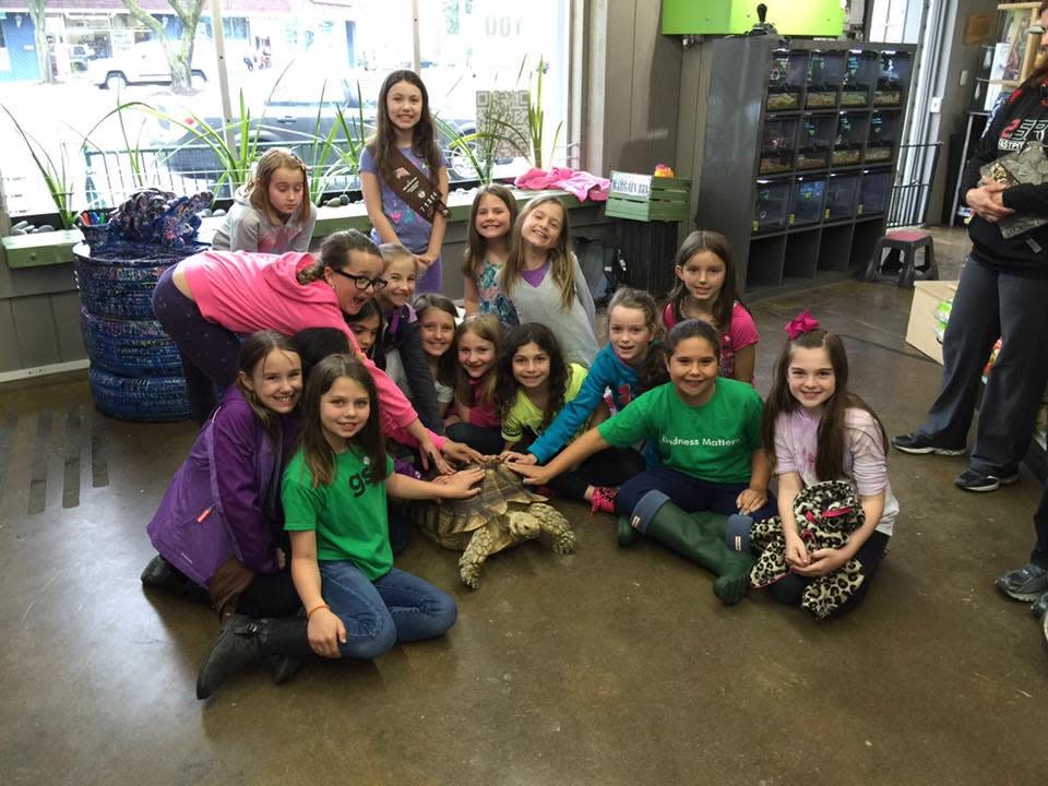Franky, the tortoise at Lou’s Pet Shop in Grosse Pointe Woods who recently died, with a Girl Scout troop.