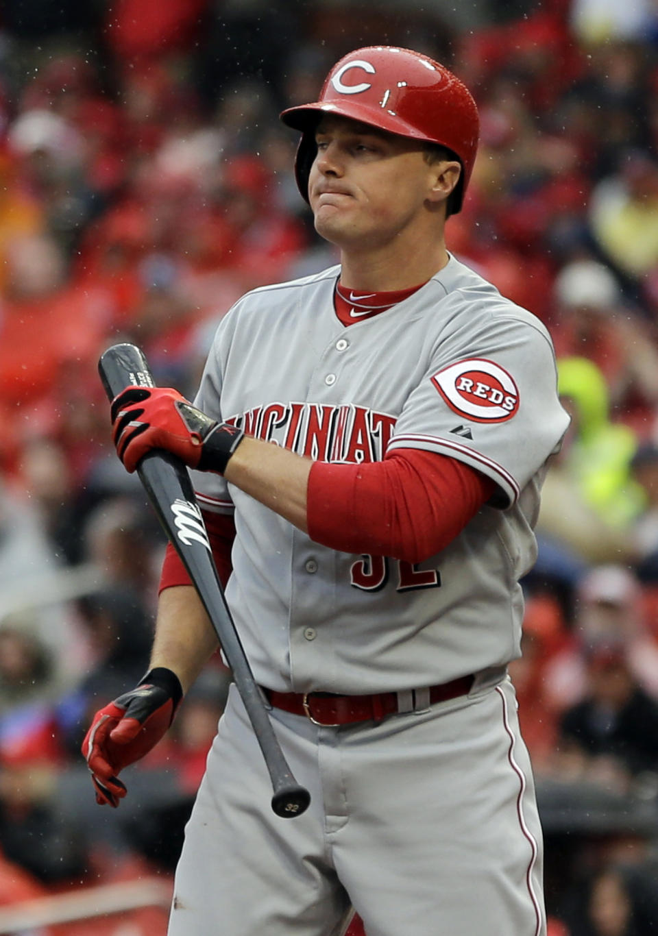 Cincinnati Reds' Jay Bruce holds his bat after striking out to end the top of the first inning of a baseball game against the St. Louis Cardinals, Monday, April 7, 2014, in St. Louis. (AP Photo/Jeff Roberson)