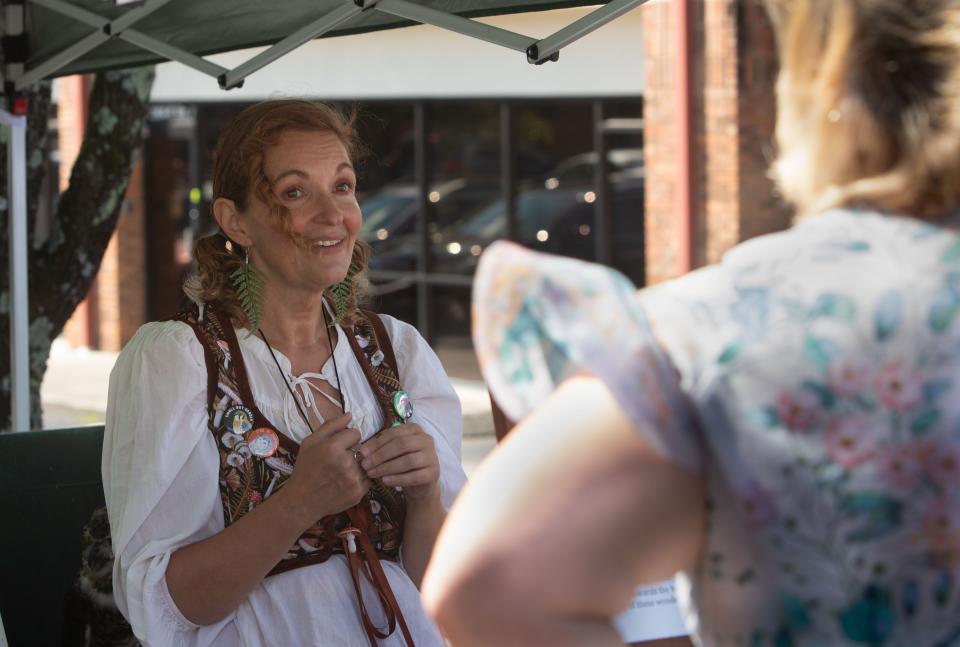 Lisa Thomison, of the Owl Ridge Raptor Center, educates attendees about her organization during Fable Hollow Coffee & Bookshoppe's first fall festival Sept. 23, 2023, in Knoxville, Tennessee.