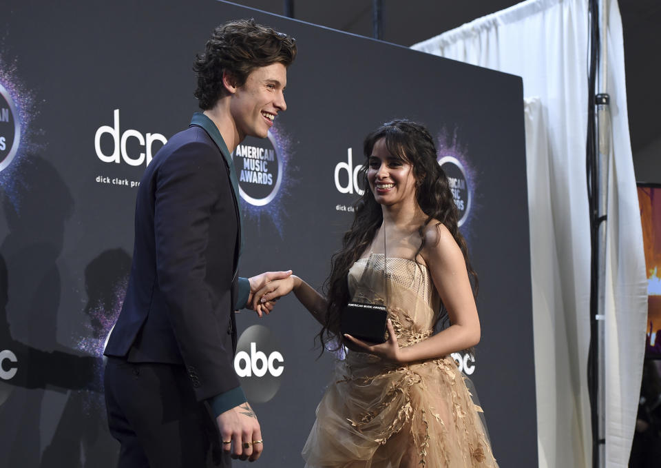 Shawn Mendes, left, and Camila Cabello pose in the press room with the award for collaboration of the year for "Señorita" at the American Music Awards on Sunday, Nov. 24, 2019, at the Microsoft Theater in Los Angeles. (Photo by Jordan Strauss/Invision/AP)