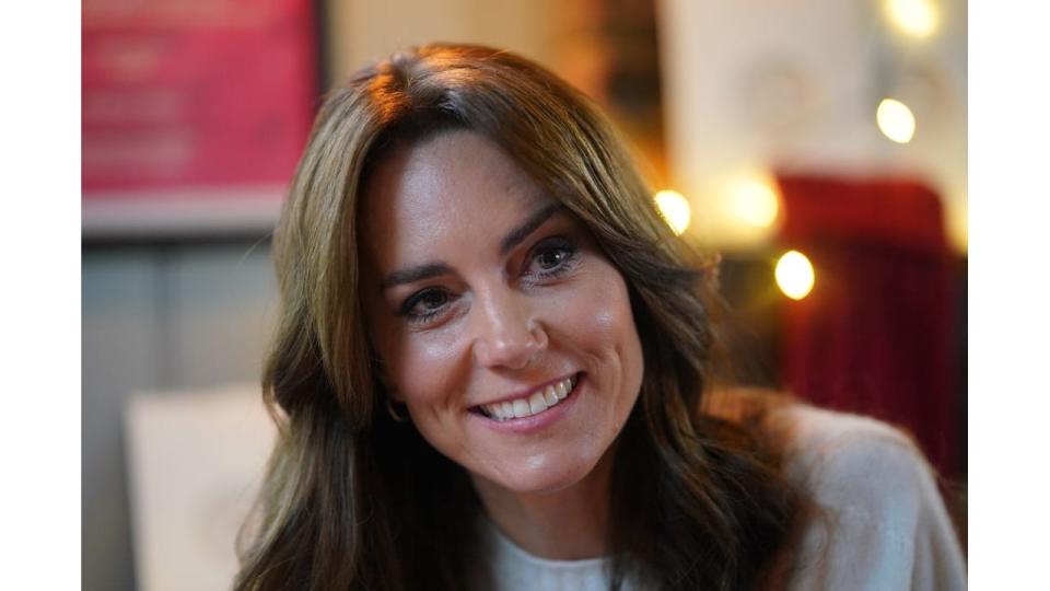 Princess Kate smiling at a table