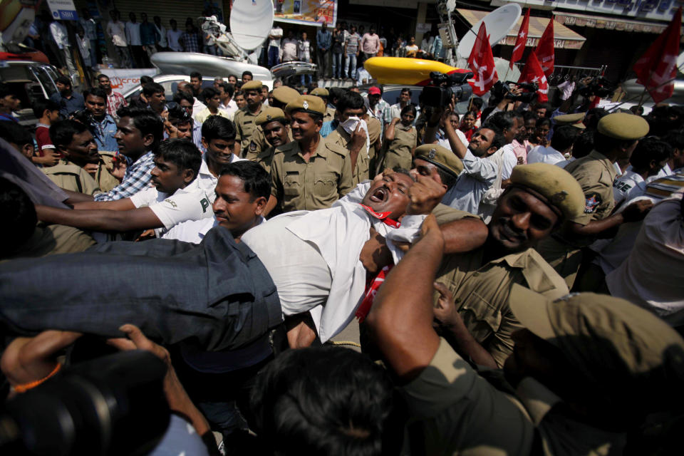 Indian policemen detain activists of left parties during a nationwide strike in Hyderabad, India, Thursday, Sept. 20, 2012. Angry opposition supporters disrupted trains in India on Thursday but had only limited success in enforcing a national strike to protest a government decision to cut fuel subsidies and open the country's huge retail market to foreign companies. (AP Photo/Mahesh Kumar A.)