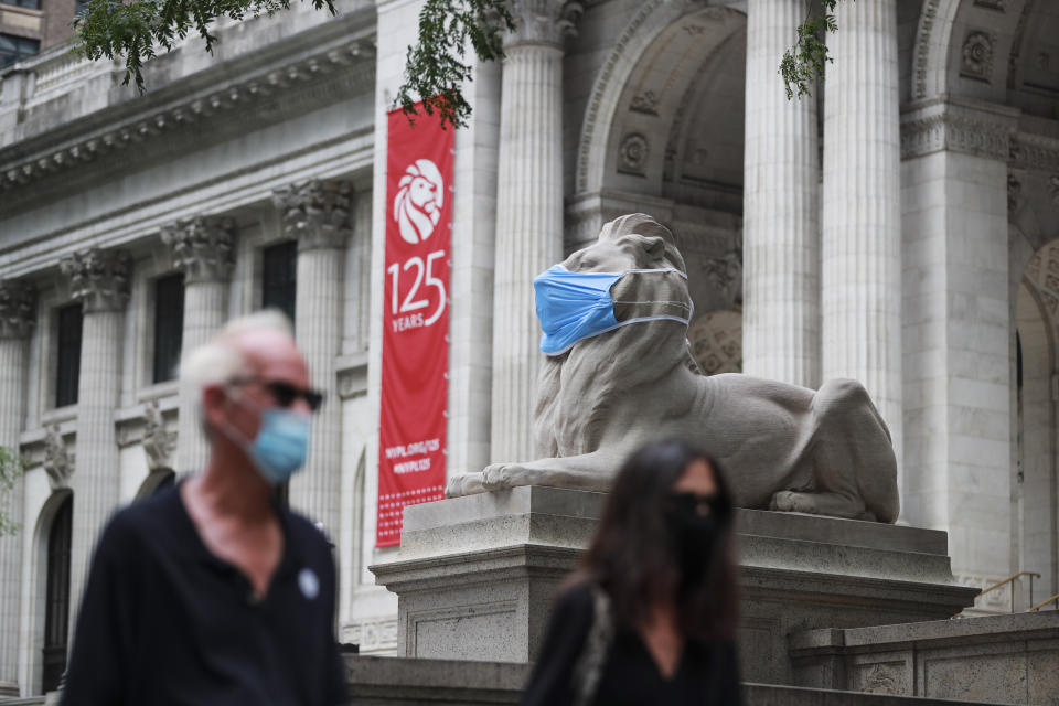 A marble lion is seen with a face mask in front of the New York Public Library on the Fifth Avenue in New York, the United States, July 8, 2020. (Wang Ying/Xinhua via Getty)