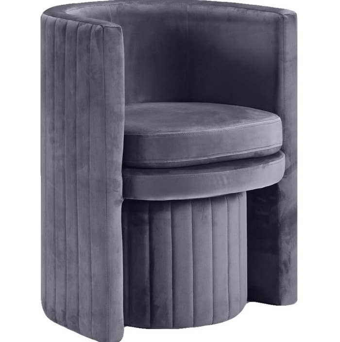 dark grey cylinder accent chair with matching ottoman