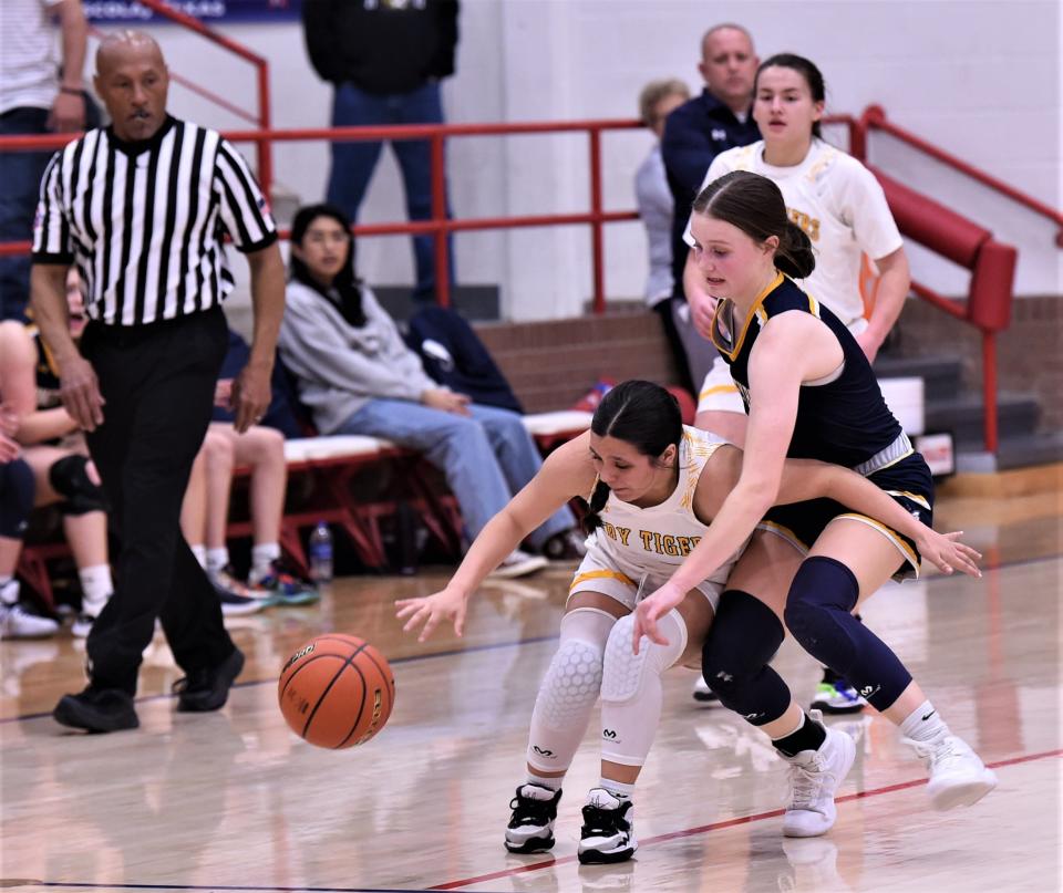 Stephenville's Lucy Espinoza, right, knocks the ball away from Snyder's Jalee Guerrero in the first half. Stephenville beat the Lady Tigers 66-30 in the Region I-4A bi-district playoff game Monday, Feb. 13, 2023, at Bill Thornton Arena in Tuscola.