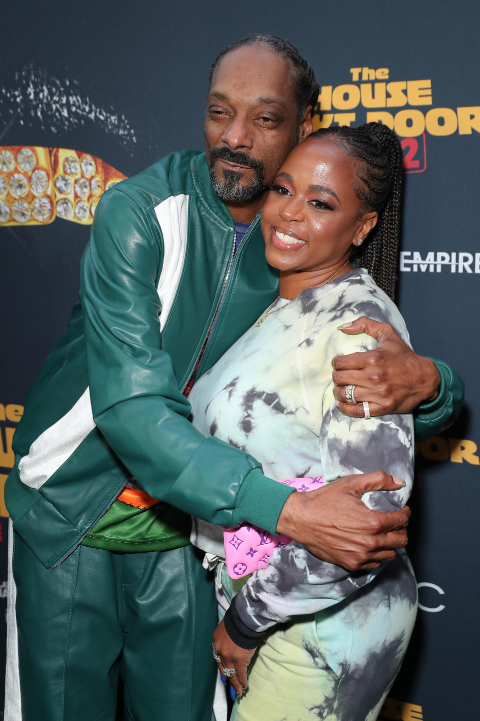 Snoop Dogg and Shante Broadus embrace on the red carpet of the "The House Next Door: Meet the Blacks 2" premiere on June 07, 2021