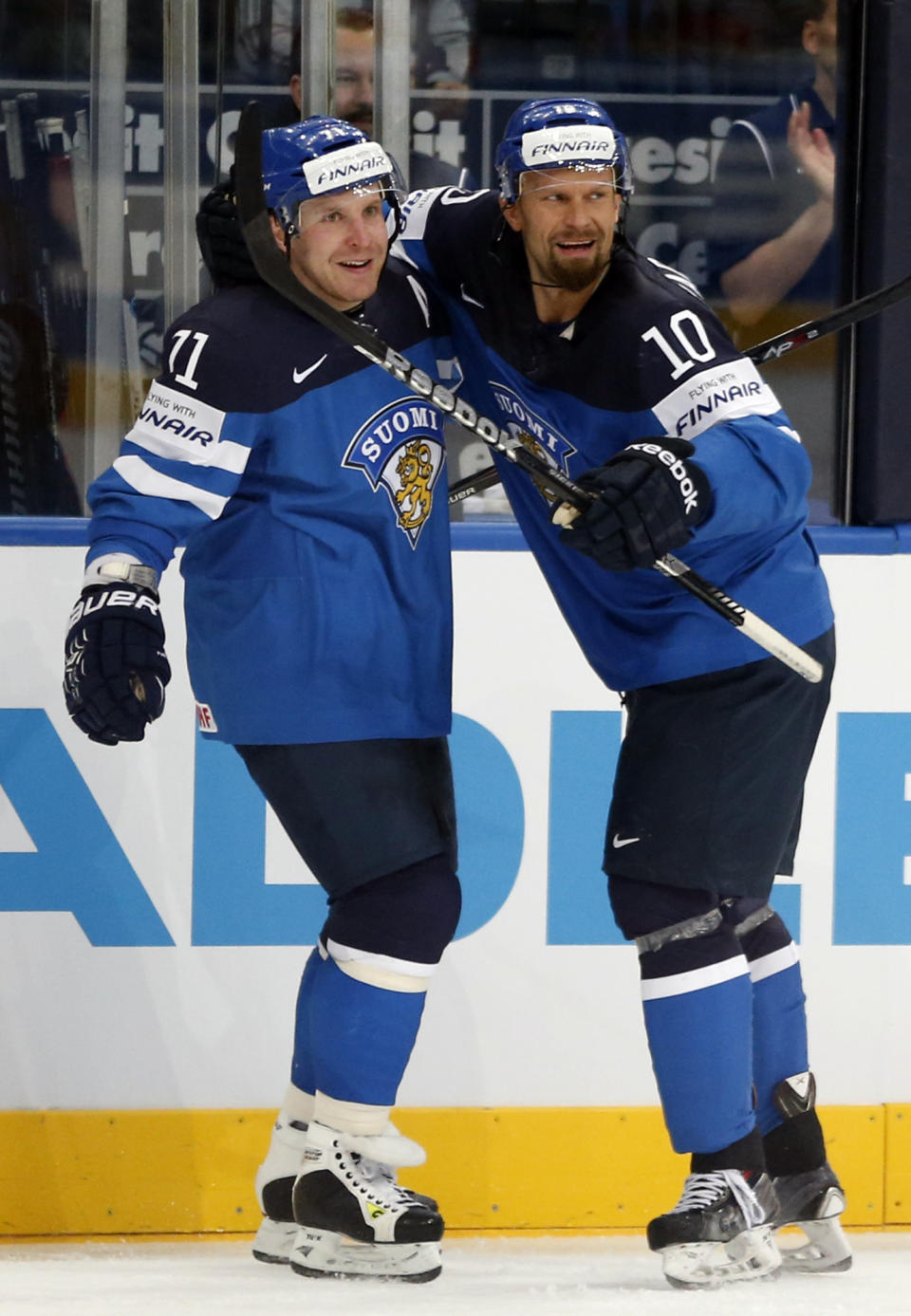 Finland forward Leo Komarov, left, celebrates a goal with Finland defender Jere Karalahti during the Group B preliminary round match between Germany and Finland at the Ice Hockey World Championship in Minsk, Belarus, Tuesday, May 13, 2014. (AP Photo/Darko Bandic)