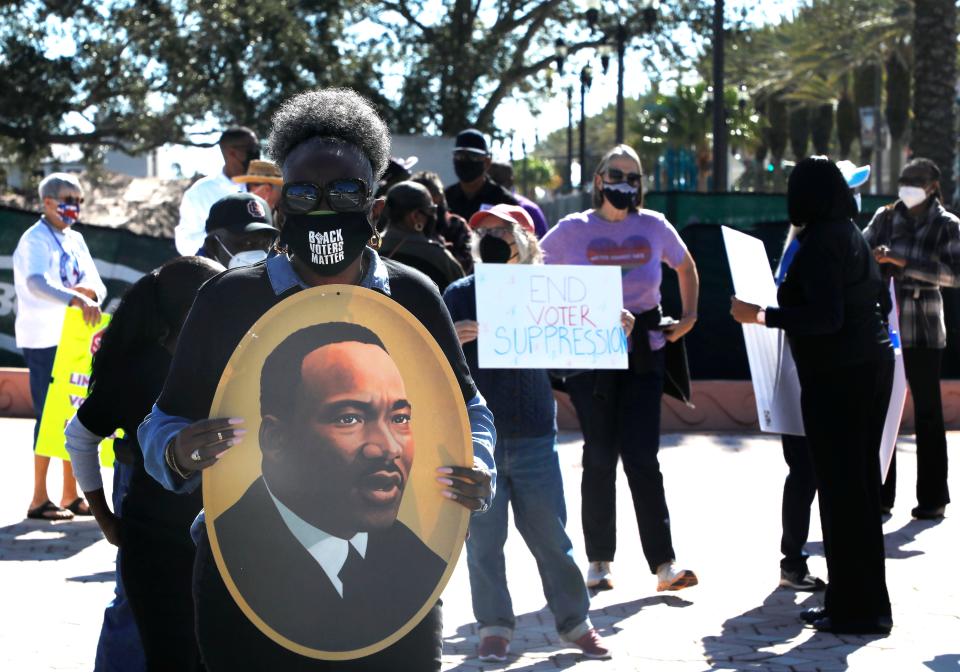 Protesters gather at the base of the International Speedway Boulevard bridge in Daytona Beach in support of the John Lewis Voting Rights Act. Rev. Larry Chavers said that "If we don’t ever participate in what is going on, we will never know what we can do."