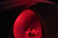 Sandy Chang and Orson Cheong relax on the floor inside Exxopolis, an inflatable walk-in luminarium at Grand Park in Los Angeles, California, September 7, 2013. The inflatable walk-in luminarium, designed by Architects of Air, creates a maze of winding paths and domes featuring Islamic architecture, Archimedean solids, and Gothic cathedral designs. REUTERS/Jonathan Alcorn (UNITED STATES - Tags: SOCIETY)