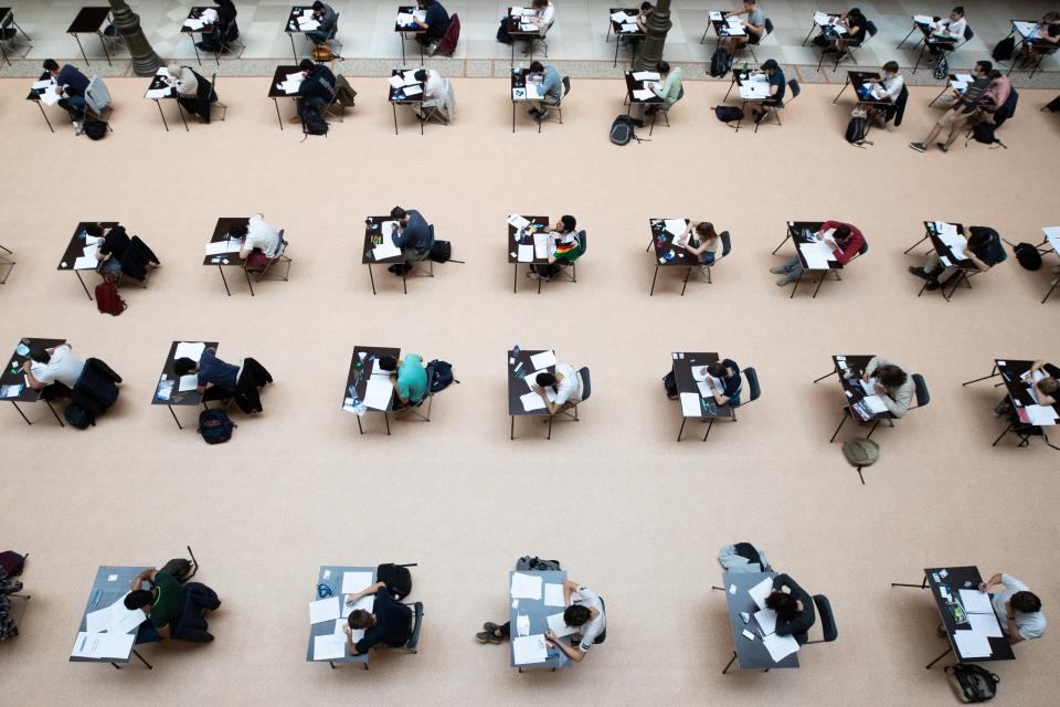 University students of the Vrije Universiteit Brussel (VUB), some wearing protective facemasks, pass their exams at the Art and History Museum in order to respect the social distancing rule, in Brussels, on June 2, 2020 as Belgium eases lockdown measures taken to curb the spread of the COVID-19 (the novel coronavirus). (Photo by BENOIT DOPPAGNE / BELGA / AFP) / Belgium OUT (Photo by BENOIT DOPPAGNE/BELGA/AFP via Getty Images)