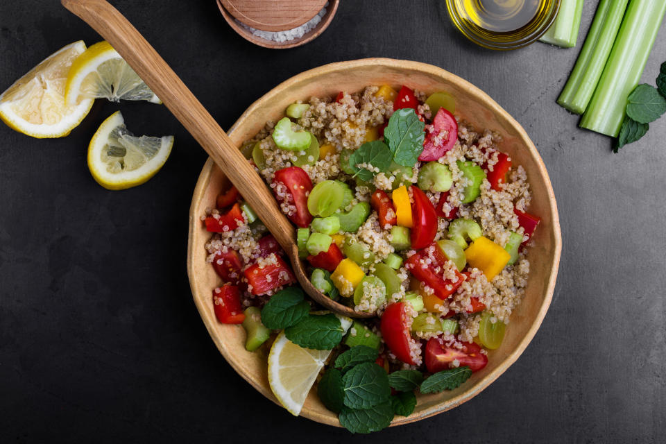 A quinoa salad with tomato and cucumber.