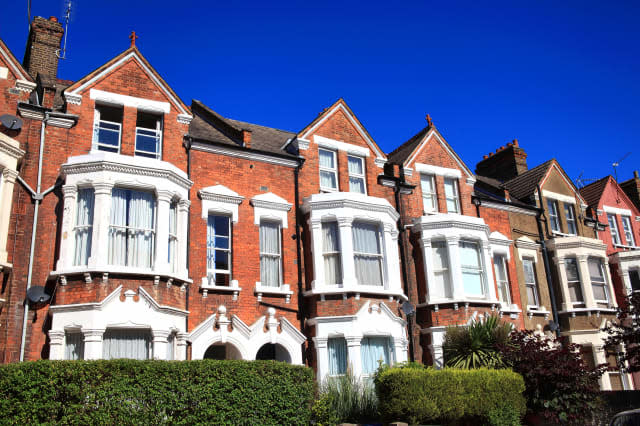 Old fashioned typical Victorian terraced town houses architecture in London, England, UK. These residential homes are often turn