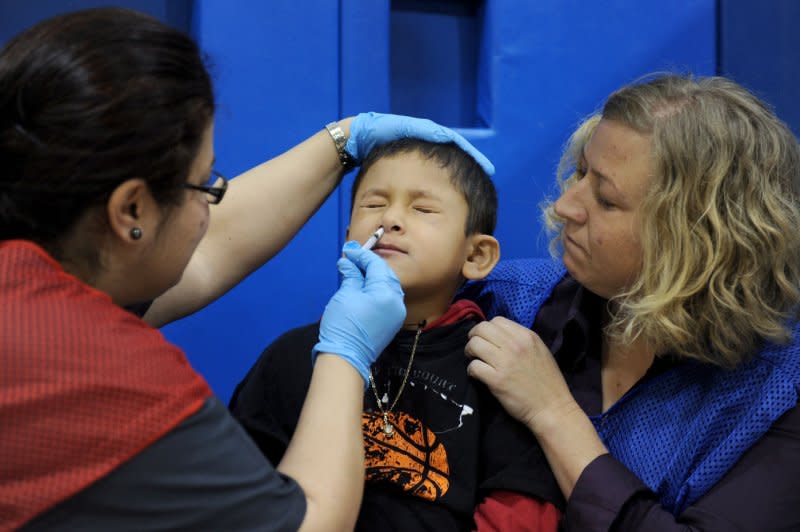 A young boy receives an inhaled H1N1 flu vaccine dose from a nurse at Carlin Springs Elementary School in Arlington, Va., on January 7, 2010. On October 24, 2009, U.S. President Barack Obama declared a national emergency related to the outbreak of the H1N1 flu virus, also known as swine flu. File Photo by Roger L. Wollenberg/UPI