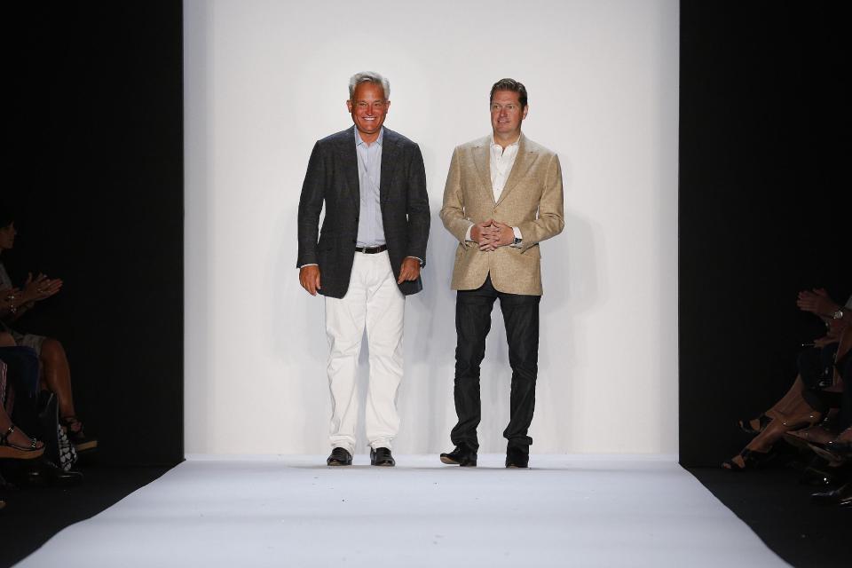 Mark Badgley, left, and James Mischka greet the audience after their Spring 2014 collection was modeled during Fashion Week in New York, Tuesday, Sept. 10, 2013. (AP Photo/John Minchillo)