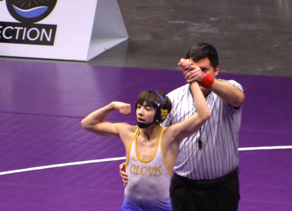 Anthony Garza of Clovis flexes after defeating Blake Woodward of Buchanan at the Central Section Masters at Selland Arena in Fresno, California on Saturday, Feb. 17, 2024.