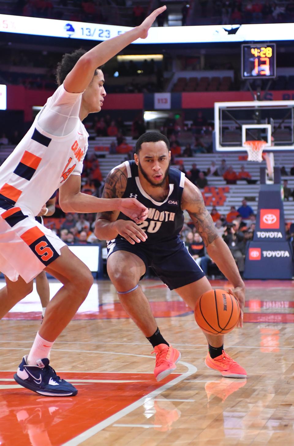 Monmouth Hawks guard Tahron Allen (20) drives the ball as Syracuse Orange center Jesse Edwards (14) defends in the first half at JMA Wireless Dome.