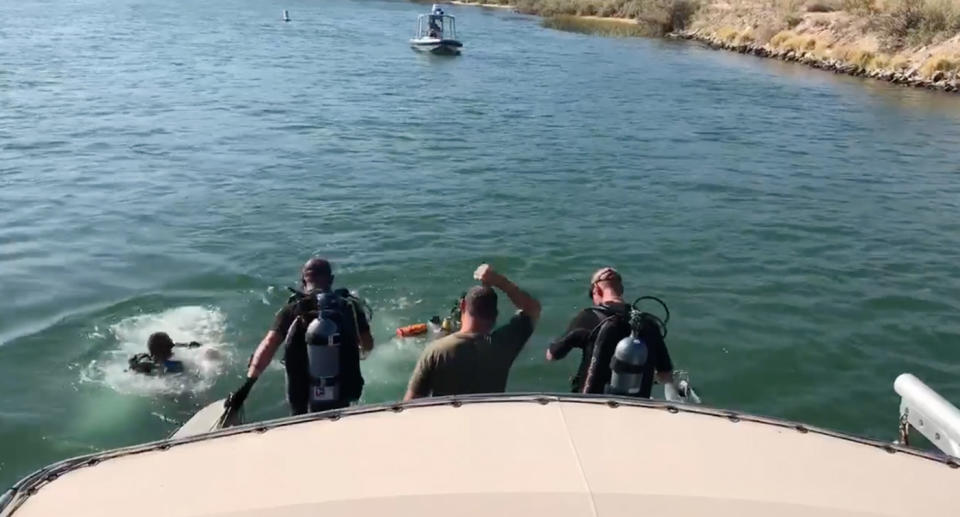 Police divers searching the Colorado river in California, USA after a boat crash (pictured)