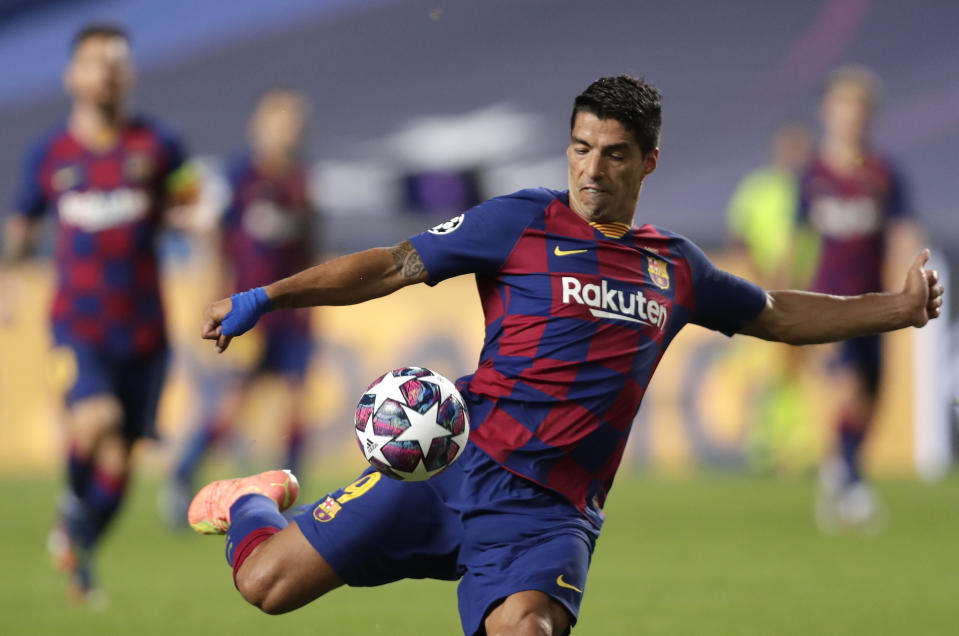 Barcelona's Luis Suarez kicks the ball during the Champions League quarterfinal match between FC Barcelona and Bayern Munich at the Luz stadium in Lisbon, Portugal, Friday, Aug. 14, 2020. (AP Photo/Manu Fernandez/Pool)